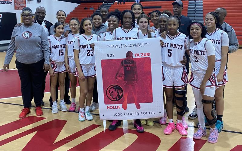 Fort White guard Zuri Hollie was honored for hitting the 1,000-point mark in her career during the Indians’ 69-38 win over Trenton in the District 6-R semifinals on Wednesday. (COURTESY)