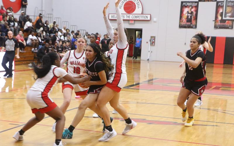 Fort White guard Mariah Cox (1) is swarmed by Hilliard defenders during Friday's 56-37 loss in the Region 3-R finals. (MORGAN MCMULLEN/Lake City Reporter)