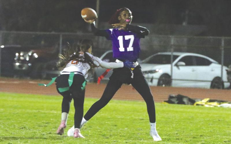 Columbia quarterback Marli Mosley gets off a pass just before an Orange Park defender can make the sack during Tuesday's 20-0 loss. (MORGAN MCMULLEN/Lake City Reporter)