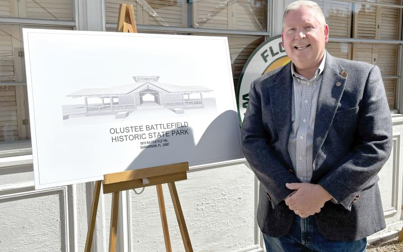 Rep. Chuck Brannan is pictured next to a rendering of the new Olustee Battlefield Historic State Park museum during the groundbreaking ceremony Friday at the park. (COURTESY)