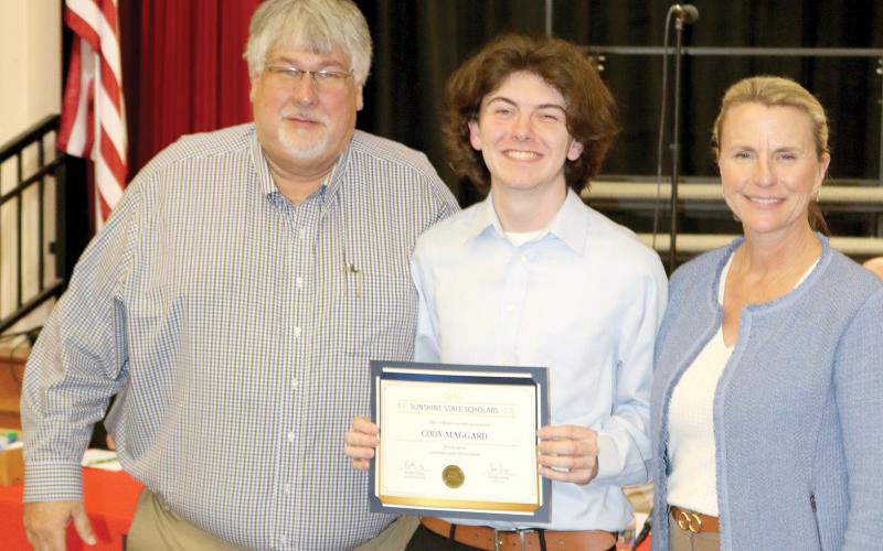 Fort White student Cody Maggard was recognized by the Columbia County School Board on Tuesday for being named the district’s Sunshine State Scholar. Maggard is pictured with Superintendent Keith Couey and School Board Chair Dana Brady-Giddens. (TONY BRITT/Lake City Reporter)
