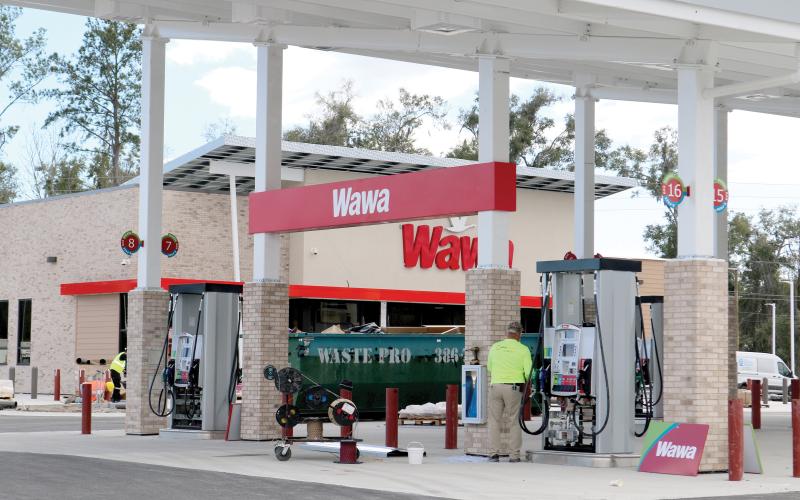 Signage was erected Tuesday on the Wawa convenience store at the U.S. Highway 90 and Ridgewood Avenue intersection. The store is expected to open in April. (TONY BRITT/Lake City Reporter)