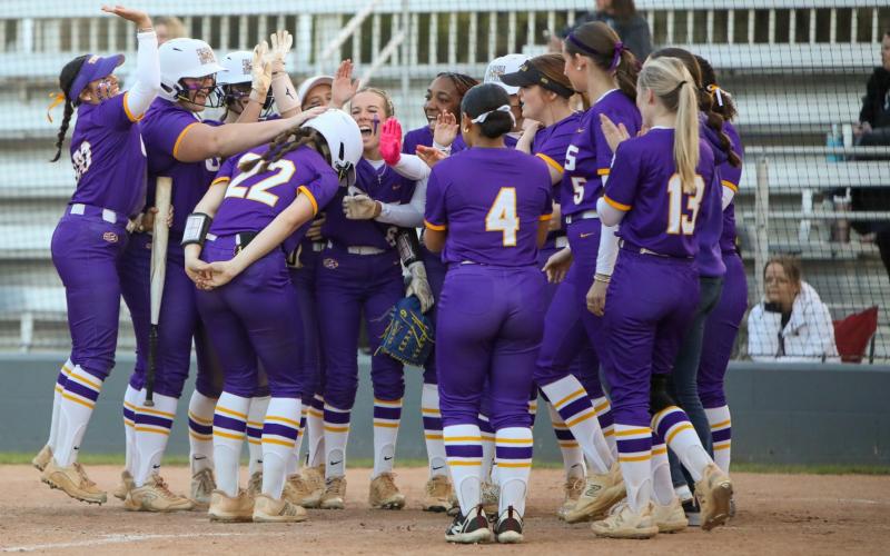 Columbia catcher Emily Delgado (22) is greeted at home plate by her teammates after hitting a two-run home run against Bartram Trail on Thursday. (BRENT KUYKENDALL/Lake City Reporter)