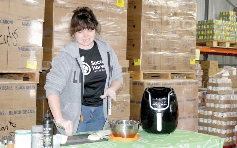 Merrick Mitchell, a nutrition educator, prepares turnips during a food demonstration at Catholic Charities on Wednesday, kicking off its annual March against Hunger campaign. (TONY BRITT/Lake City Reporter)