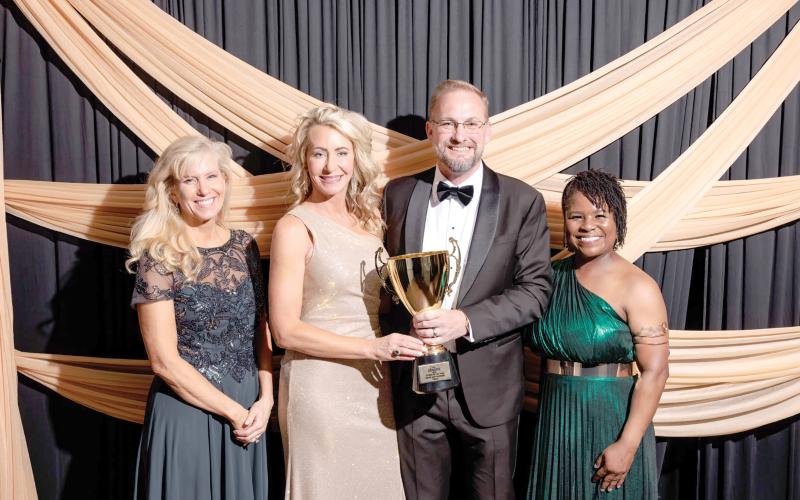 David and Ashleigh Pitzer were named the Suwannee County Chamber of Commerce Citizens of the Year at the Chamber Gala on Saturday night. The Pitzers were honored by Julie Ulmer (left), the Chamber’s new president, and Executive Director Danielle Hampton. (DENVER JERNIGAN/Special to the Reporter)