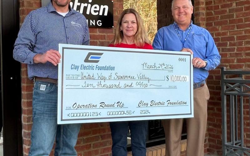 United Way of Suwannee Valley Executive Director Jennifer Anchors receives the $10,000 contribution from the Clay Electric Foundation from Jordan Wade, member relations representative (left), and District Manager Troy Adams. (COURTESY)