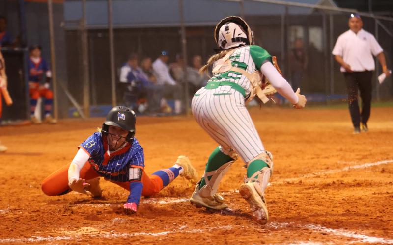 Branford right fielder Aurelia Darling slides safely into home plate past Suwannee catcher Addison Peterson on Thursday. (PAUL BUCHANAN/Lake City Reporter)