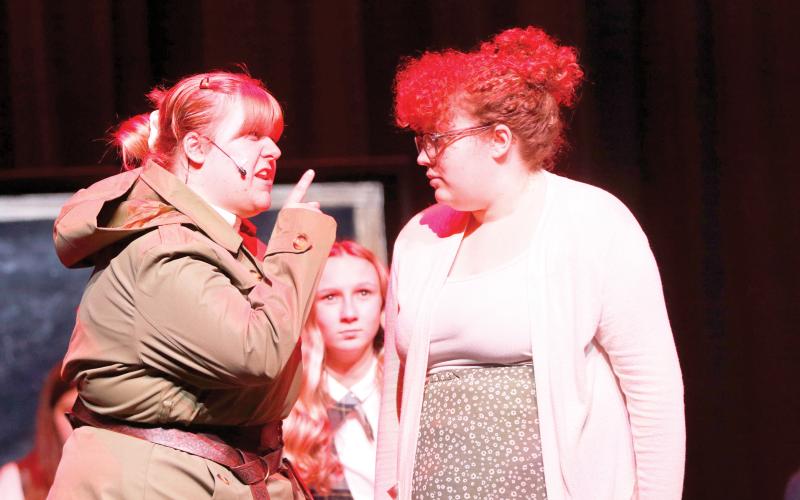 Miss Trunchbull, the headmistress at the school in ‘Matilda’ played by Lillian Sasser (left) scolds Matilda’s teacher Miss Honey, played by Jamylai Leon, during a scene from the Suwannee High theater troupe’s rehearsal for this weekend’s performances. (JAMIE WACHTER/Lake City Reporter)