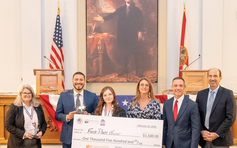 North Florida College student Lillian Clay, of Suwannee County, holds the winning check after winning the inaugural Sunshine State Debate. Florida Commissioner of Education Anastasios Kamoutsas stands to her left, holding the trophy Clay won. (COURTESY NORTH FLORIDA COLLEGE)