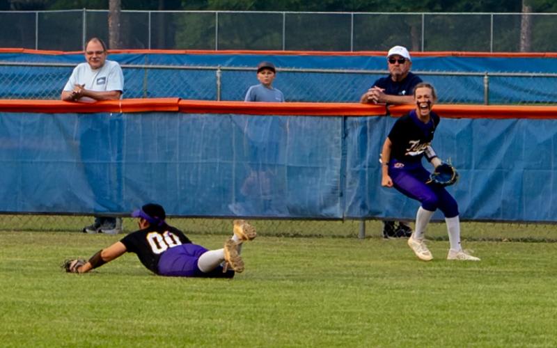 Columbia left fielder Addyson Sherman (right) celebrates after center fielder Luisa Taylor (00) makes a diving catch for an out against Branford on Tuesday. (JACK HOWDESHELL/Lake City Reporter)