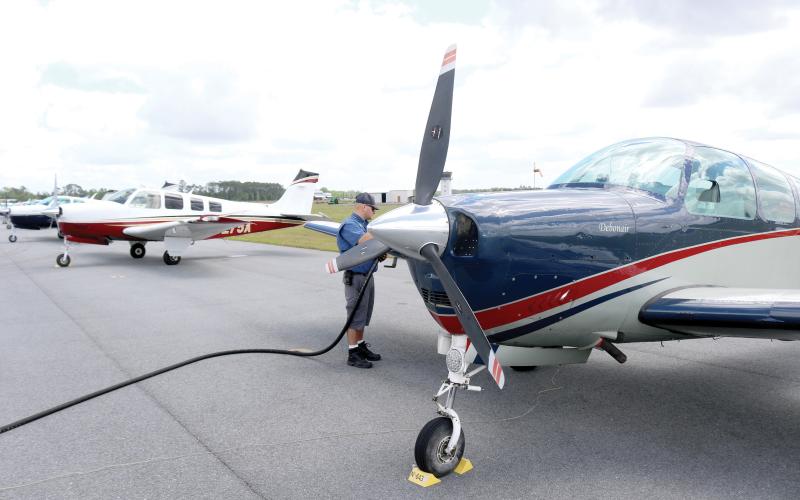Casey Roach, a lineman at the Lake City Gateway Airport, fuels a Bonanza on Friday afternoon. At least 30 of the Beechcraft airplanes are at the airport practicing for a Wisconsin air show. (TONY BRITT/Lake City Reporter)
