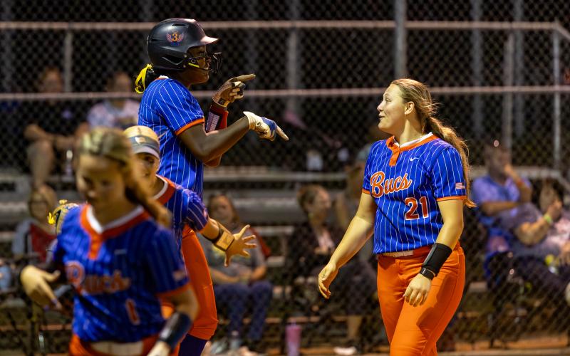 Branford first baseman Mallory Blue (left) celebrates with pitcher Harleigh Price after hitting a three-run home run against Fort White in the District 6-R semifinals on Tuesday. (JACK HOWDESHELL/Lake City Reporter)