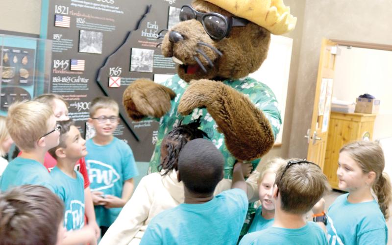 Local elementary school students meet Bellamy Beaver during a water conservation and quality event at Ichetucknee Springs State Park on Thursday morning. (TONY BRITT/Lake City Reporter)