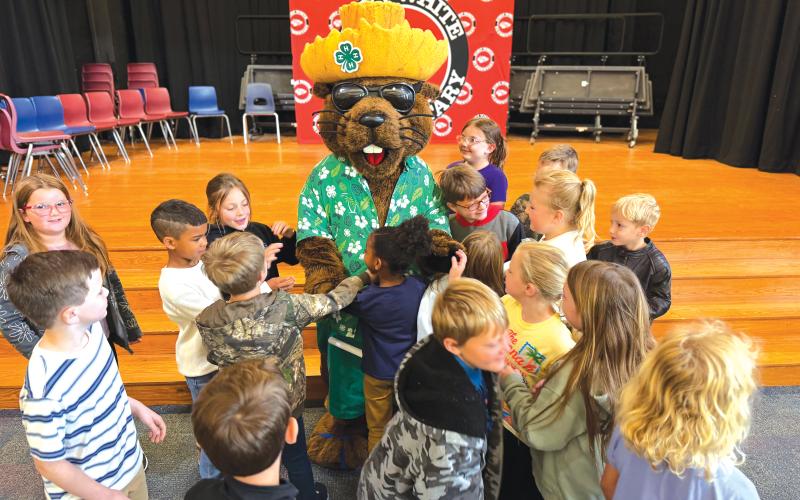 Fort White Elementary School second graders crowd Bellamy Beaver at the end of his visit to the school. (COURTESY)