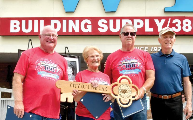 Live Oak Mayor Frank Davis (right) presented a key to the city to W.B. Howland Company owner Lyn Fletcher (second from right), Barbara Howland and Bill Howland during the company’s 100-year celebration Saturday. (ROB WOLFE/Lake City Reporter)