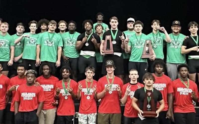District 3-2A Olympic champion Suwannee and runner-up Middleburg show off their trophies and medals on Saturday. (COURTESY)