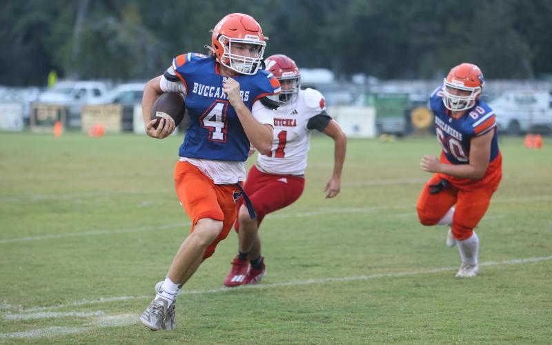 Branford quarterback Trent Land breaks into the open field against Wewahitchka last season. (FILE)