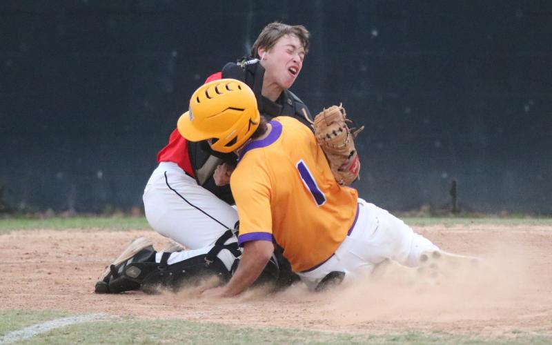 Columbia third baseman Goose Lord (1) is tagged out at home plate by Bishop Kenny catcher Timmy Pellicer on Wednesday night. (JORDAN KROEGER/Lake City Reporter)