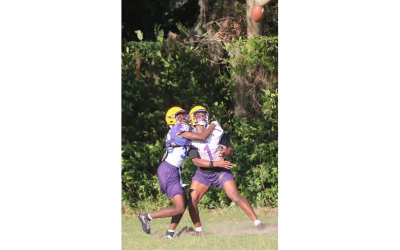 Columbia receiver Zion Walker (right) fights off cornerback Monterrence Williamson to make a catch during spring practice on Wednesday. (JORDAN KROEGER/Lake City Reporter)