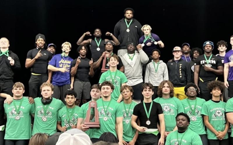 District 3-2A traditional champion Columbia and runner-up Suwannee show off their trophies and medals on Saturday. (COURTESY)