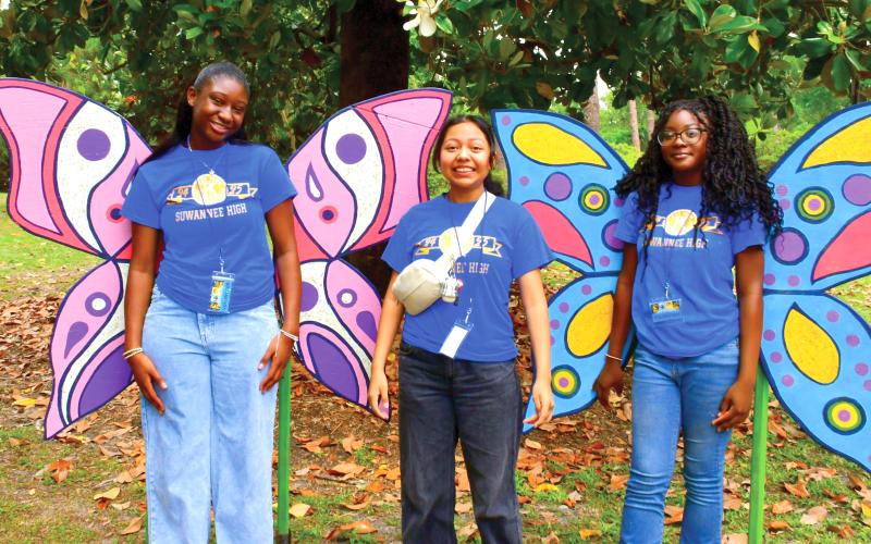 Members of the Suwannee High Key Club pose in front of a butterfly photo area at last year’s Wildflower Festival. (FILE)