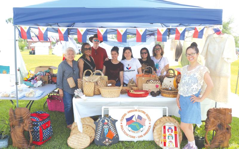 Members of the Filipino-American Cultural Society pose in their booth at last year’s Multi-Culutural Spring Market Festival near Darby Pavilion at Wilson Park. (FILE)