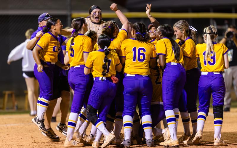 Columbia players celebrate in the circle after beating Baker County 6-2 to win the Region 1-4A title Thursday night. (JACK HOWDESHELL/Lake City Reporter)