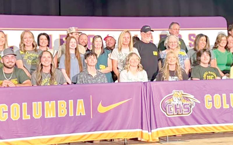 Eight Columbia High seniors — Calvin Sullivan, Casen Maddox, Ava Christie, Kali Kennington, Adyson Vercher, Griffin Roberts, Shelby Minton and Allie Brush — are joined by family as they are honored for planning to continue their education at Florida Gateway College. (COURTESY)