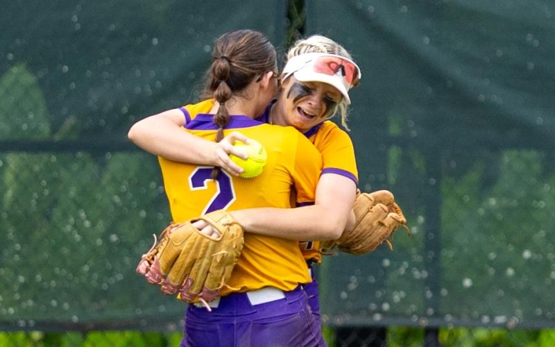 Columbia shortstop Alannah Lord (2) hugs right fielder Marlee Hunt after Hunt caught the final out of Saturday's 3-2 win over Lake Wales in the Class 4A state championship. (JACK HOWDESHELL/Lake City Reporter)