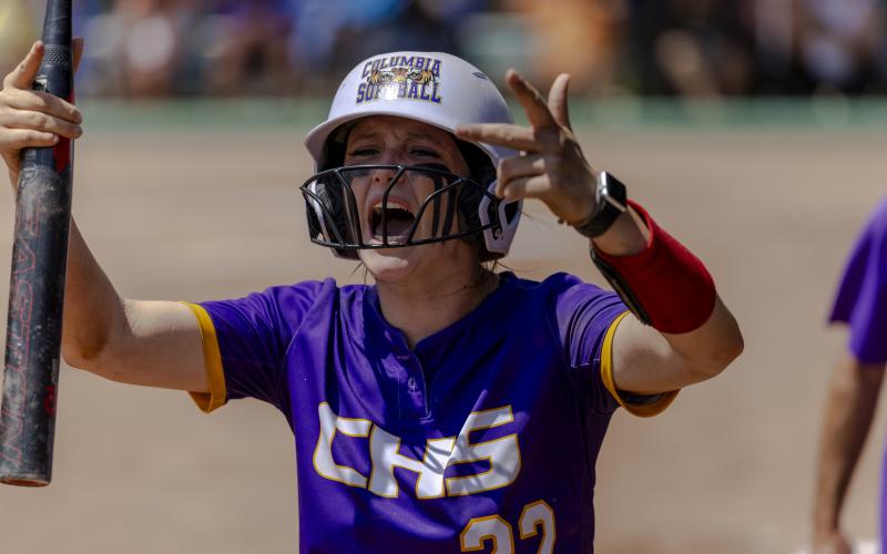Columbia catcher Emily Delgado encourages the CHS student section to get up for her team after scoring a run following her RBI double in the seventh inning of Thursday's Class 4A state semifinal against Seminole. (JACK HOWDESHELL/Lake City Reporter)