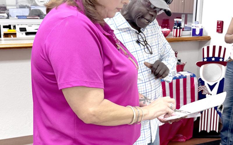 Suwannee County Supervisor of Elections Jennifer Kinsey shows Live Oak City Councilman Tommie Jefferson the vote totals from Tuesday’s city election. Jefferson advanced to a runoff election for the District 1 seat. (JAMIE WACHTER/Lake City Reporter)