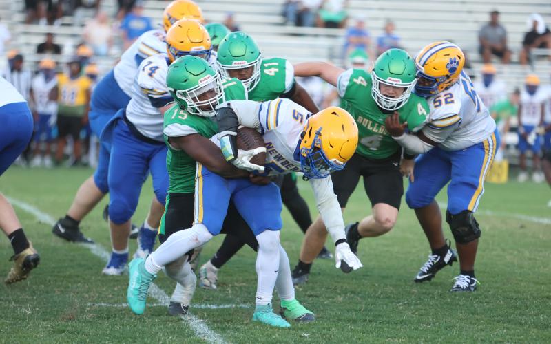 Photos by PAUL BUCHANAN/Lake City Reporter Suwannee linebacker Marcos Rojas tries to bring down Newberry running back Jamarcus Wimberly during Friday’s spring game.