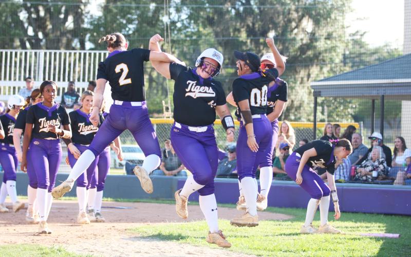 Columbia third baseman Josie Raulerson celebrates with teammates after hitting a solo home run against Arnold in the Region 1-4A semifinals on Wednesday. (JORDAN KROEGER/Lake City Reporter)