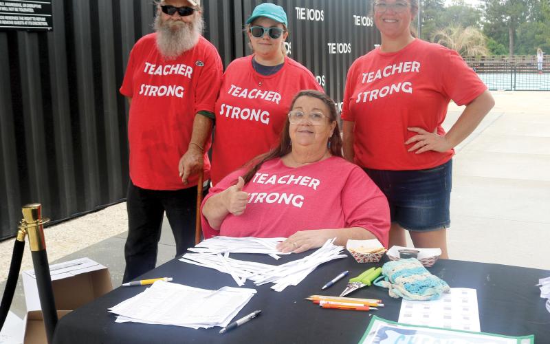James Delaney (from left), Julia Jones, Jenee Delaney, president of the Columbia Teachers Association, and Kristen Smith, Columbia Teachers Association Executive Board member, pose for a picture while welcoming local educators to the 2026 Teacher Fête on Saturday at The Woods. (TONY BRITT/Lake City Reporter)