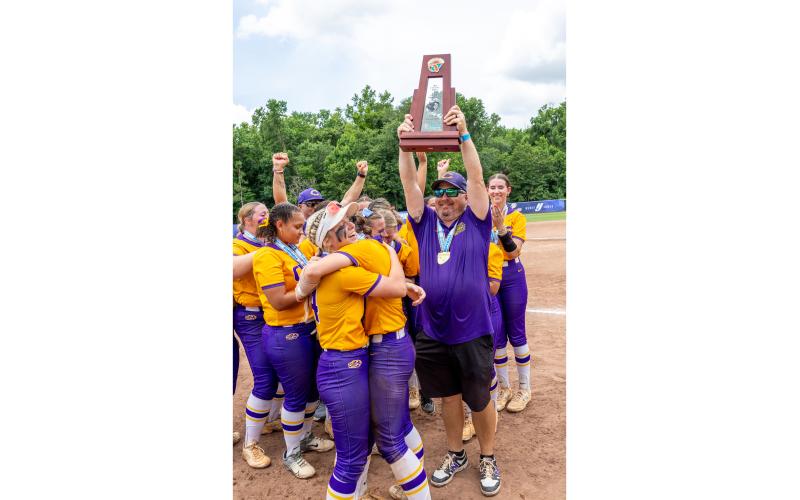 Columbia coach Joe Saucier raises the Class 4A championship trophy after the Tigers defeated Lake Wales on May 23. (JACK HOWDESHELL/Lake City Reporter)