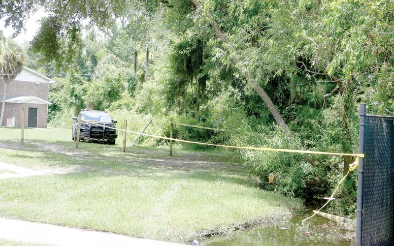 An area outside an apartment building is blocked off Tuesday afternoon following a fatal late-morning shooting outside an apartment building on NW Albright Place on the north side of Lake City. (MORGAN MCMULLEN/Lake City Reporter)