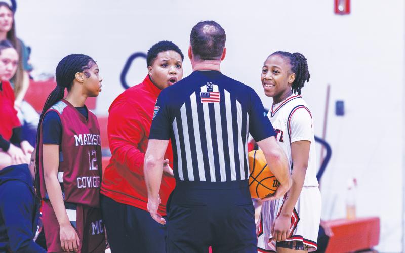 Fort White coach Bregay Harris questions a call to a referee while guard Javiona Roberson (right) smiles during the Region 3-R semifinals against Madison County on Feb. 13. (FILE)