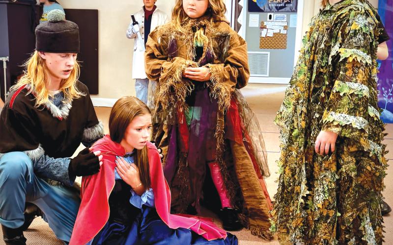 Abram Webb (from left) as Kristoff, Ainzli Kenney as Anna, Chatlynn Childs as Bulda, and Emery Webb as Pabbie rehearse a scene for the upcoming Practically Perfect Performing Arts production of ‘Frozen Jr.’ (COURTESY)