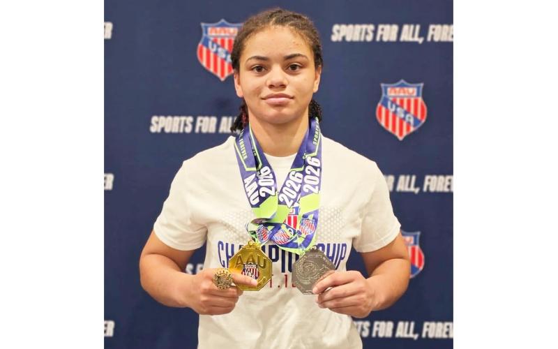 Recent Columbia graduate Bella Guerrier-Lajoir shows off her medals after going 8-0 to earn All-American honors at the AAU Scholastic Duals over the weekend. (COURTESY)