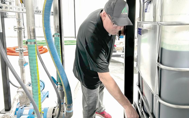 AgroLiquid site manager Jeff Herald prepares ingredients inside the Lake City facility. (COURTESY AGROLIQUID)