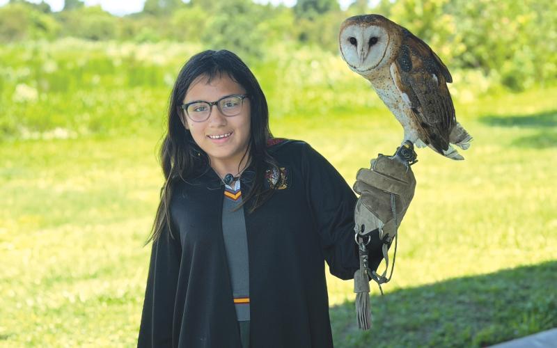 Lily Weaver gets the opportunity to hold an owl during the Columbia County 4-H Year Two session of the School of Life Skills for Magical Beings camp from June 22-26. (COURTESY COLUMBIA COUNTY 4-H)