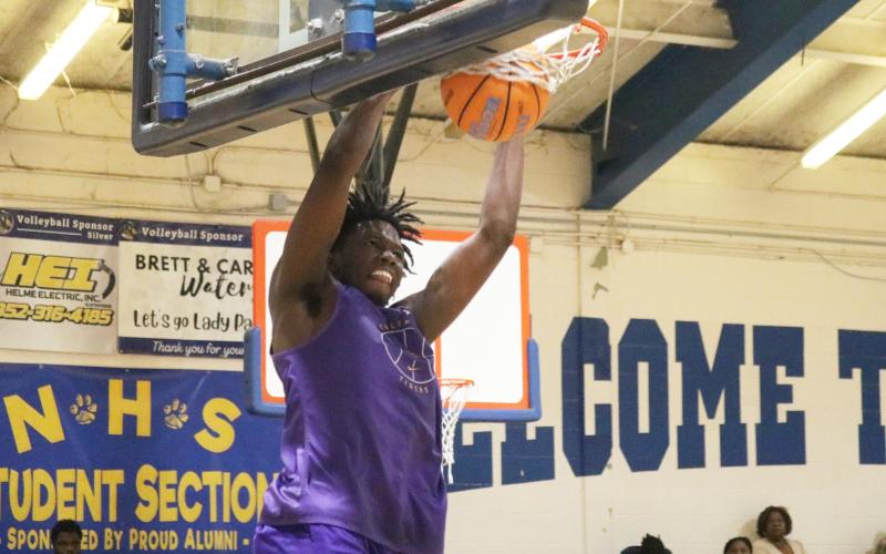 Columbia center Ty’avious Cooper dunks against Newberry during the Tigers’ summer league finale on Tuesday. (JORDAN KROEGER/Lake City Reporter)