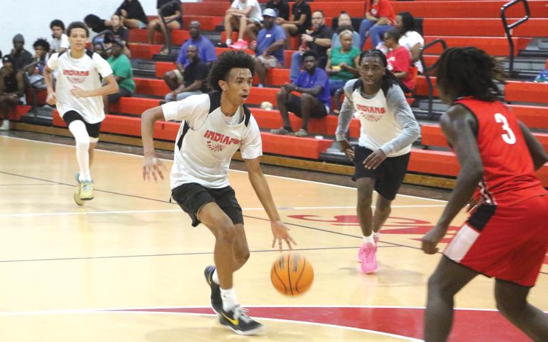 Fort White guard Tylan James drives to the basket against Williston during Tuesday’s summer league contest. (MORGAN  MCMULLEN/Lake City Reporter)