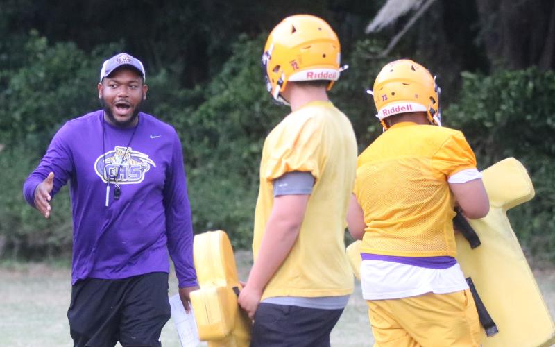 Columbia offensive line coach Anthony Newton works with his offensive line during Monday’s practice. Newton has taken over for David May, who departed after just one spring in the job. (JORDAN KROEGER/Lake City Reporter)