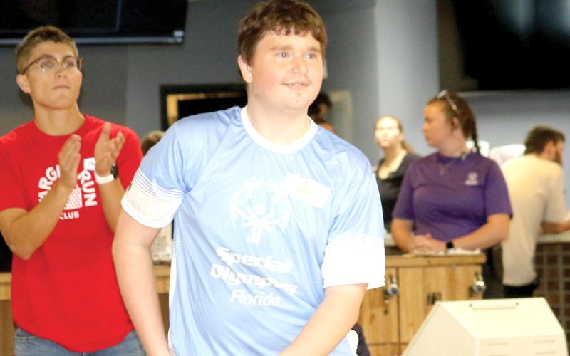 A Special Olympics Florida athlete from Columbia County looks down the lane as he releases a bowling ball during the Columbia County Special Olympics Bowling competition on Friday morning at Lake City Bowl. (TONY BRITT/Lake City Reporter)