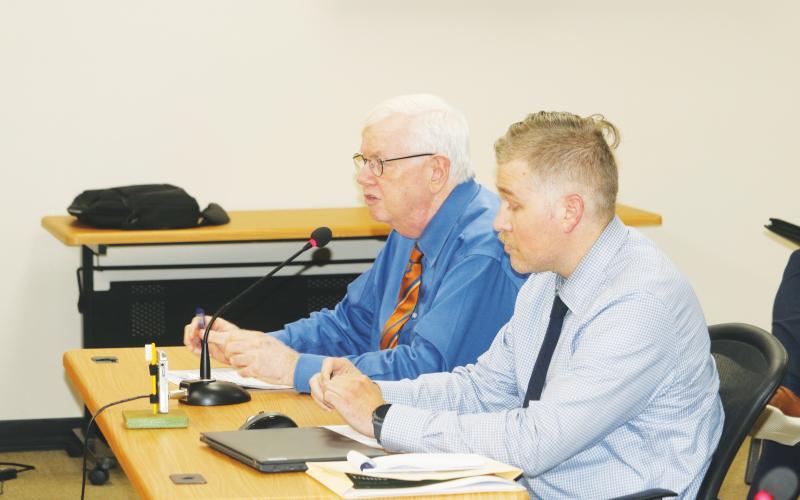 Henry Thomas and Matthew Ori of Faftelis Financial Consultants walk North Florida Water Utilities Authority board members through a series of rate increases during Monday’s meeting. (TONY BRITT/Lake City Reporter)