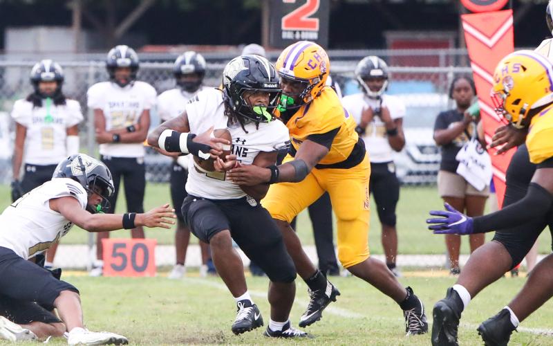 Columbia defensive end Mikel Morgan tackles Lakewood running back Amir Smith in the backfield on Friday. (BRENT KUYKENDALL/Lake City Reporter)