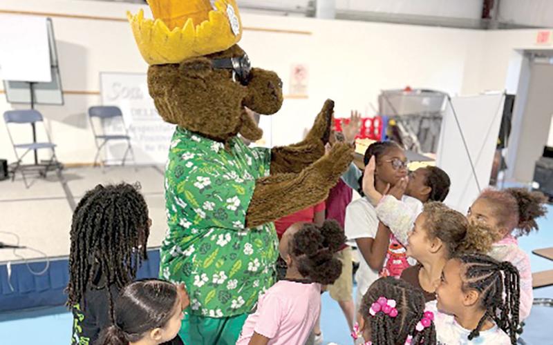 Niblack students high five Bellamy as he reminds them to ‘Turn off the Tap!’ (COURTESY UF/IFAS EXTENSION COLUMBIA COUNTY)