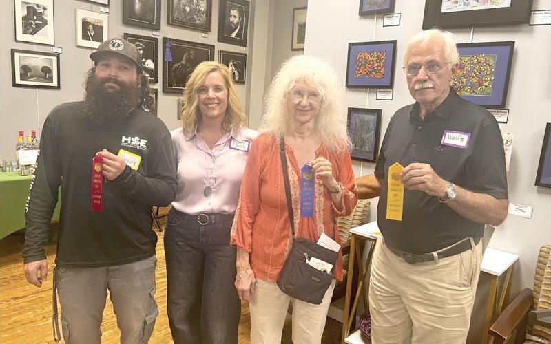 Taking the top prizes in the third annual Branford Camera Club Photography Exhibition and Competition were Georgia Schemetz (second from right), first place; Derek Linger (left), third place; and Rob Wolfe (right), honorable mention. Show coordinator Rachel Shelley is pictured with the winners. Not pictured are David Campione, who won second place, and Kathy Smith, who also captured an honorable mention. (COURTESY)