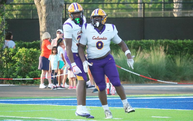 Columbia defensive tackle Jaylen Underwood (right) celebrates alongside defensive end Mikel Morgan after a sack against Bolles last Friday. (JORDAN KROEGER/Lake City Reporter)